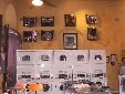 More washing machines and dryers, with photo exhibit in background.
